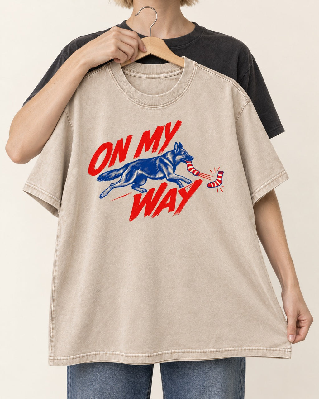 German Shepherd Dog On My Way Sock Chase Graphic Washed Tee in Apricot, held up on a hanger