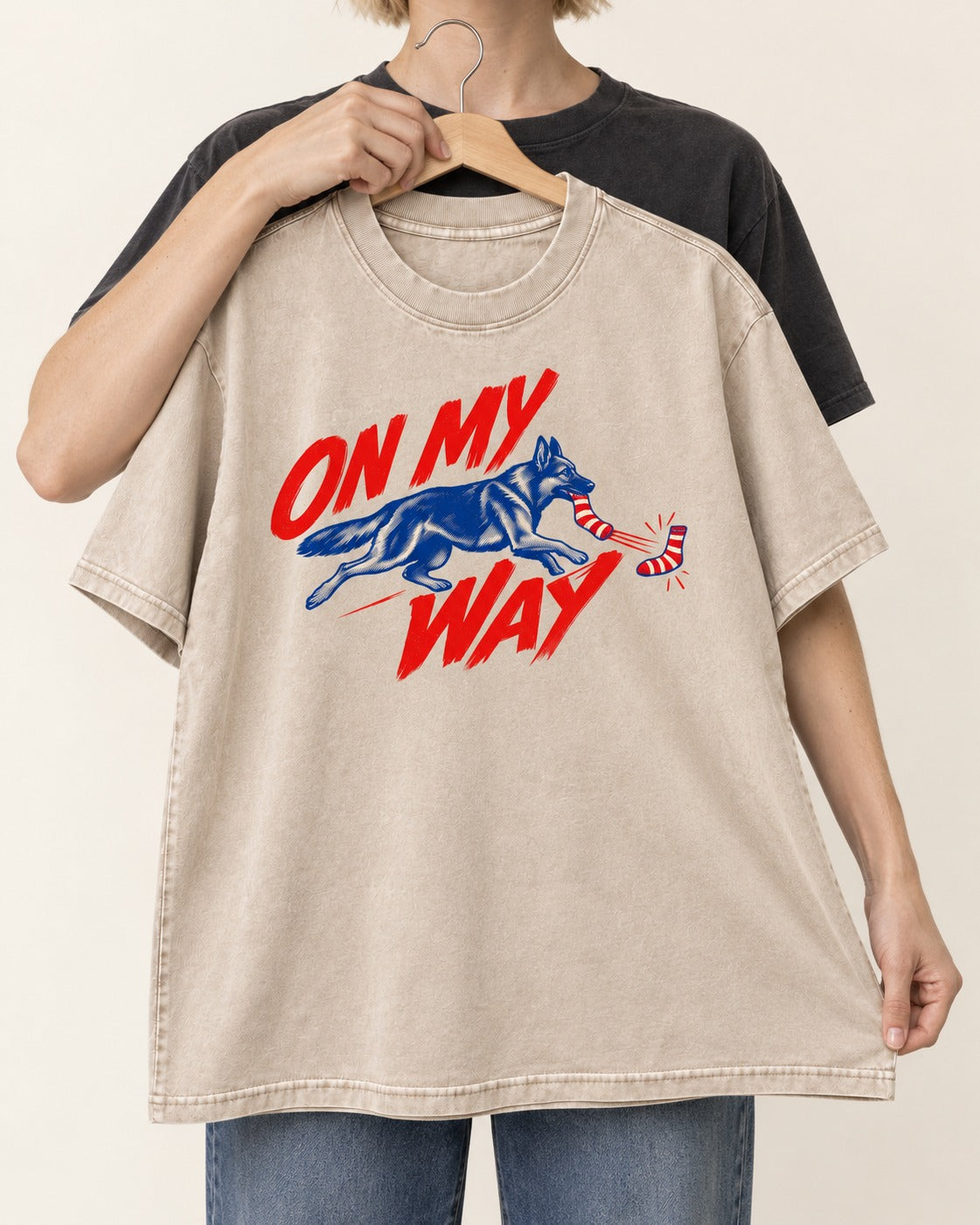 German Shepherd Dog On My Way Sock Chase Graphic Washed Tee in Apricot, held up on a hanger