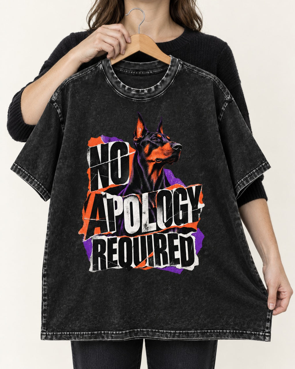Doberman No Apology Required Torn Paper Graphic Washed Tee in Black, held up on a hanger