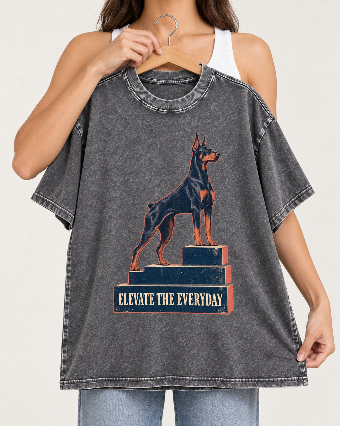 Doberman Elevate the Everyday Podium Graphic Washed Tee in Gray, held up on a hanger