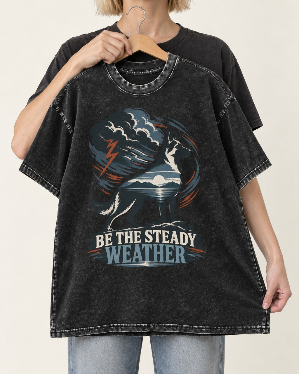 Be the Steady Weather Storm German Shepherd Dog Graphic Washed Tee in Black, held up on a hanger