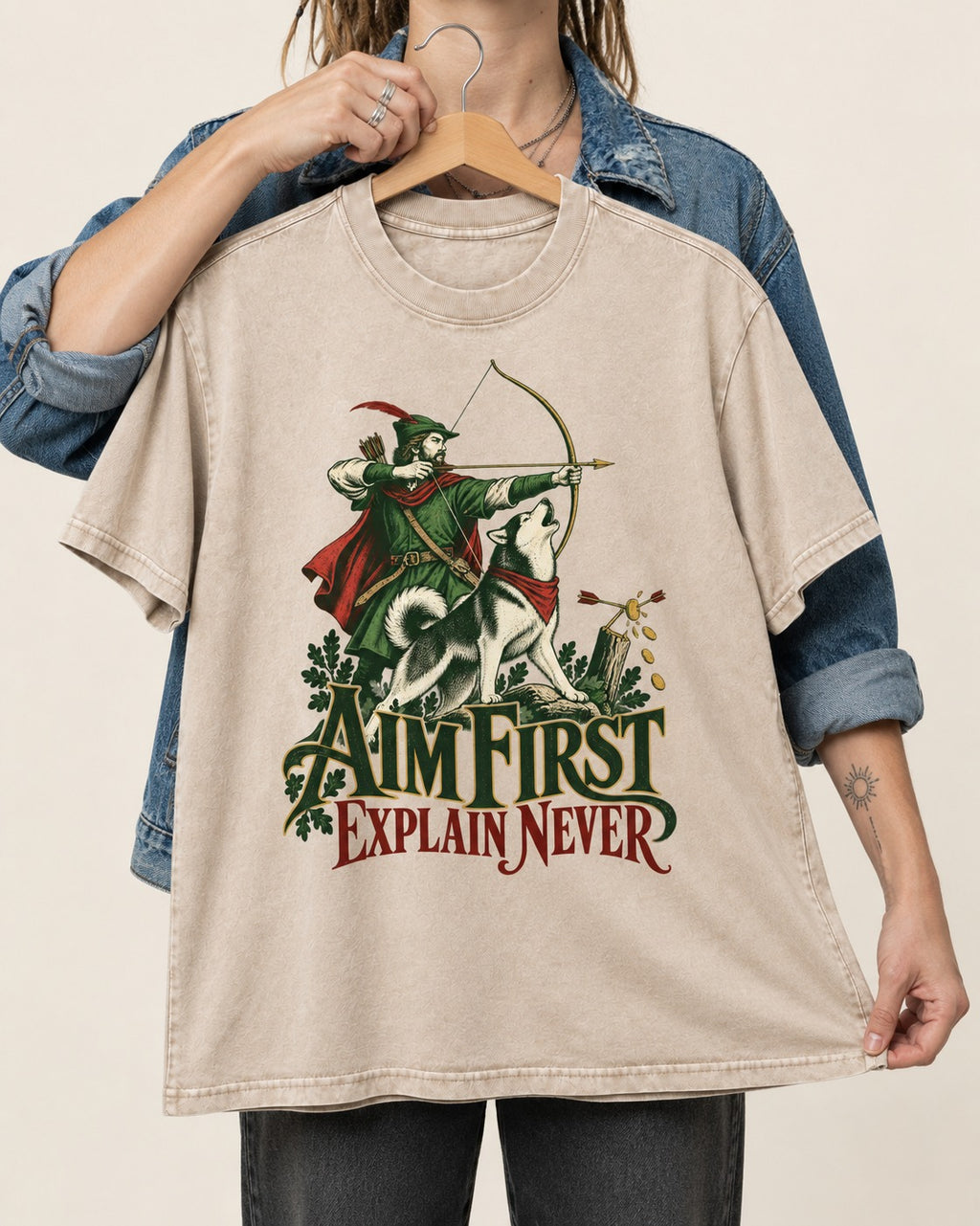 Husky Aim First Explain Never Washed Tee in Apricot, held up on a hanger