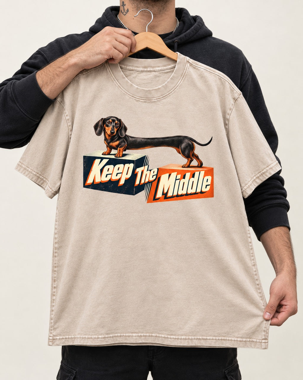 Dachshund Keep The Middle Block Bridge Graphic Washed Tee in Apricot, held up on a hanger