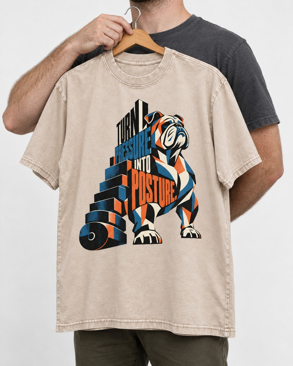Turn Pressure Into Posture English Bulldog Washed Tee in Apricot, held up on a hanger