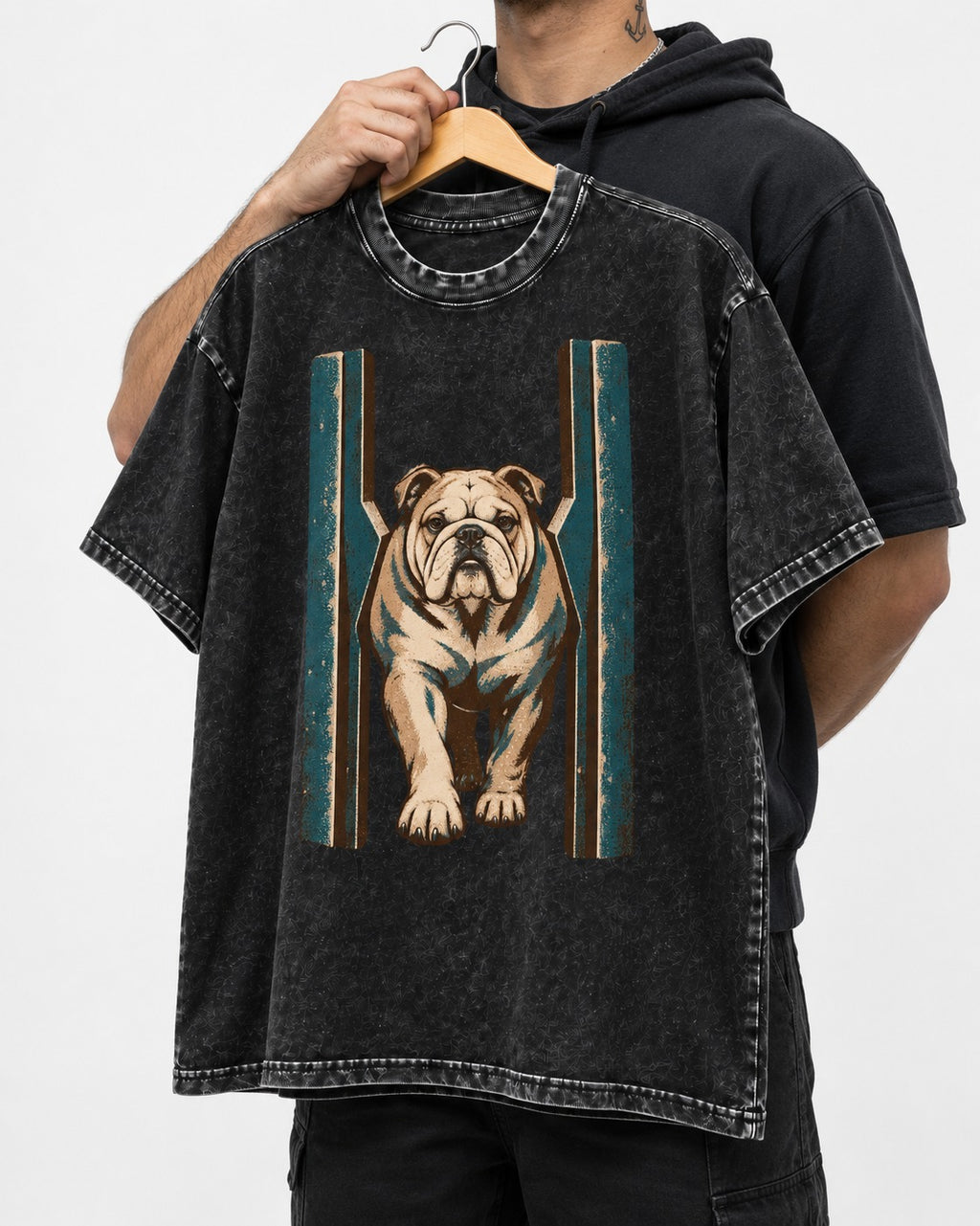 English Bulldog Walking Through Teal Gate Graphic Washed Tee in Black, held up on a hanger