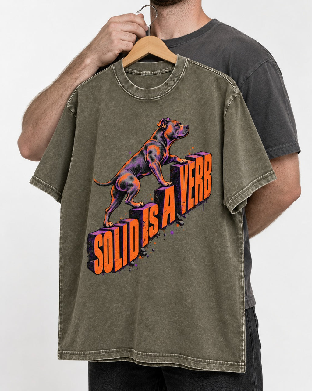 Pitbull Solid Is a Verb Step Type Graphic Washed Tee in Army Green, held up on a hanger