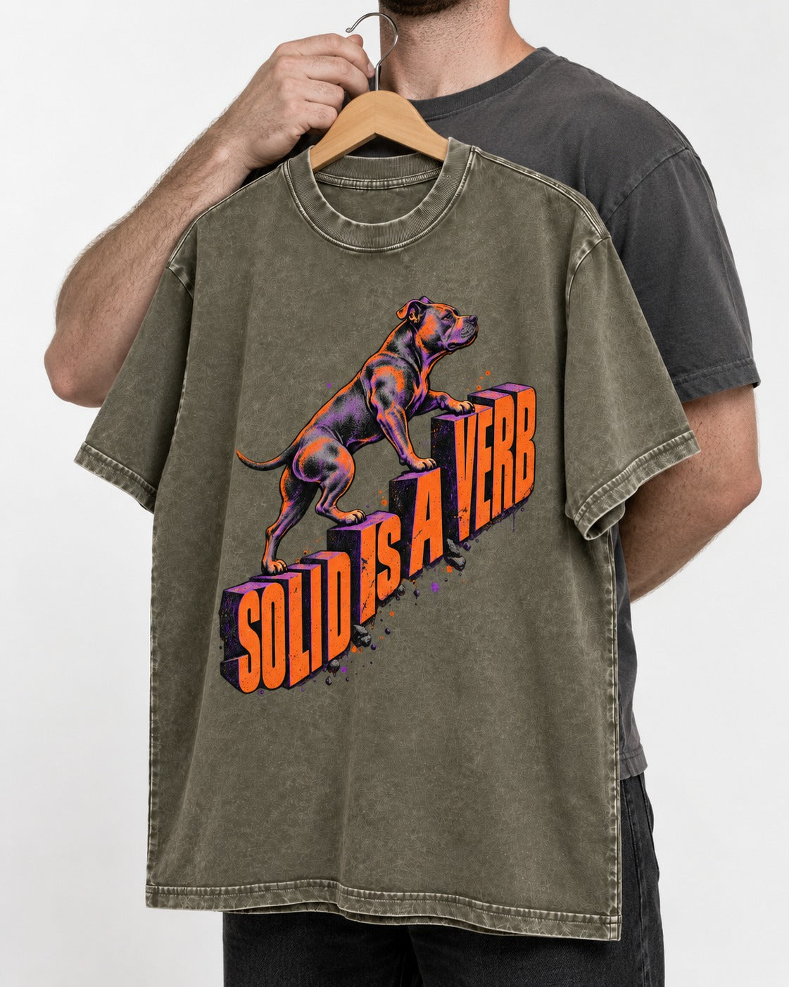 Pitbull Solid Is a Verb Step Type Graphic Washed Tee in Army Green, held up on a hanger