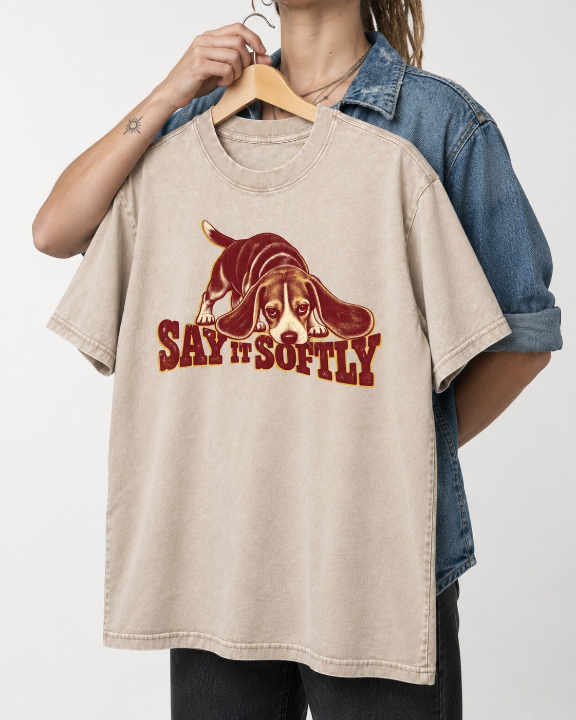 Beagle Say It Softly Washed Tee in Apricot, held up on a hanger