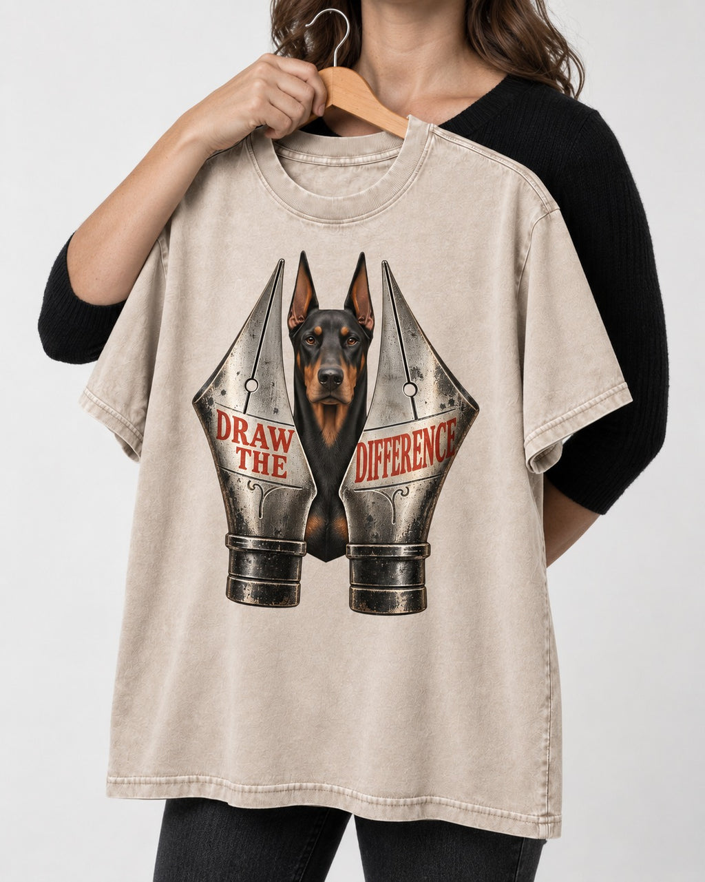 Doberman Draw the Difference Washed Tee in Apricot, held up on a hanger