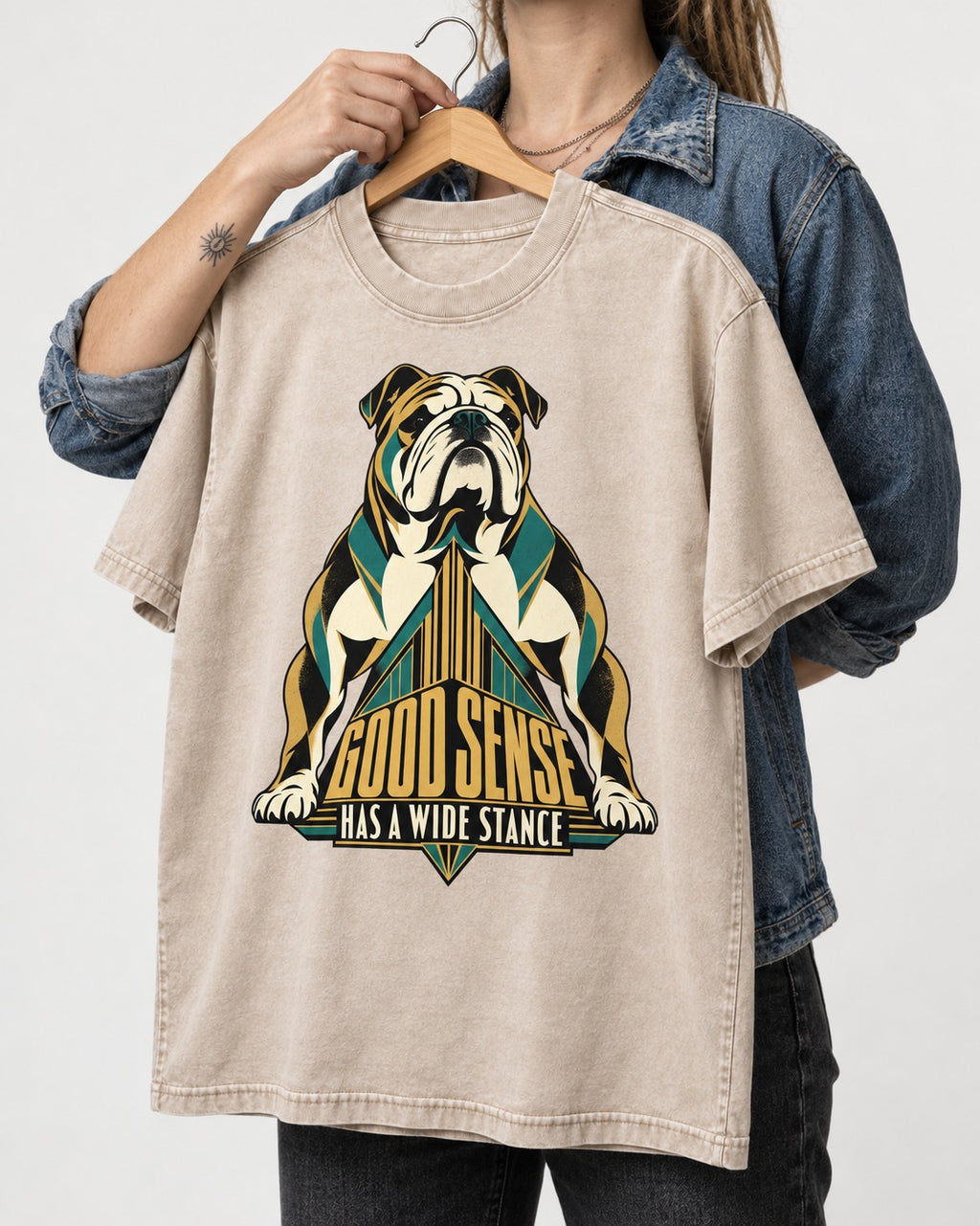 Good Sense Has a Wide Stance English Bulldog Graphic Washed Tee in Apricot, held up on a hanger