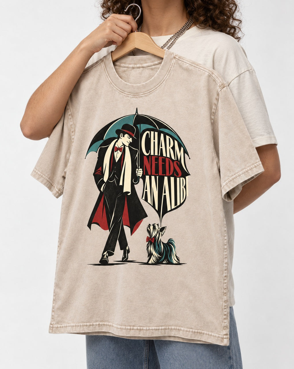 Charm Needs an Alibi Yorkshire Terrier Washed Tee in Apricot, held up on a hanger