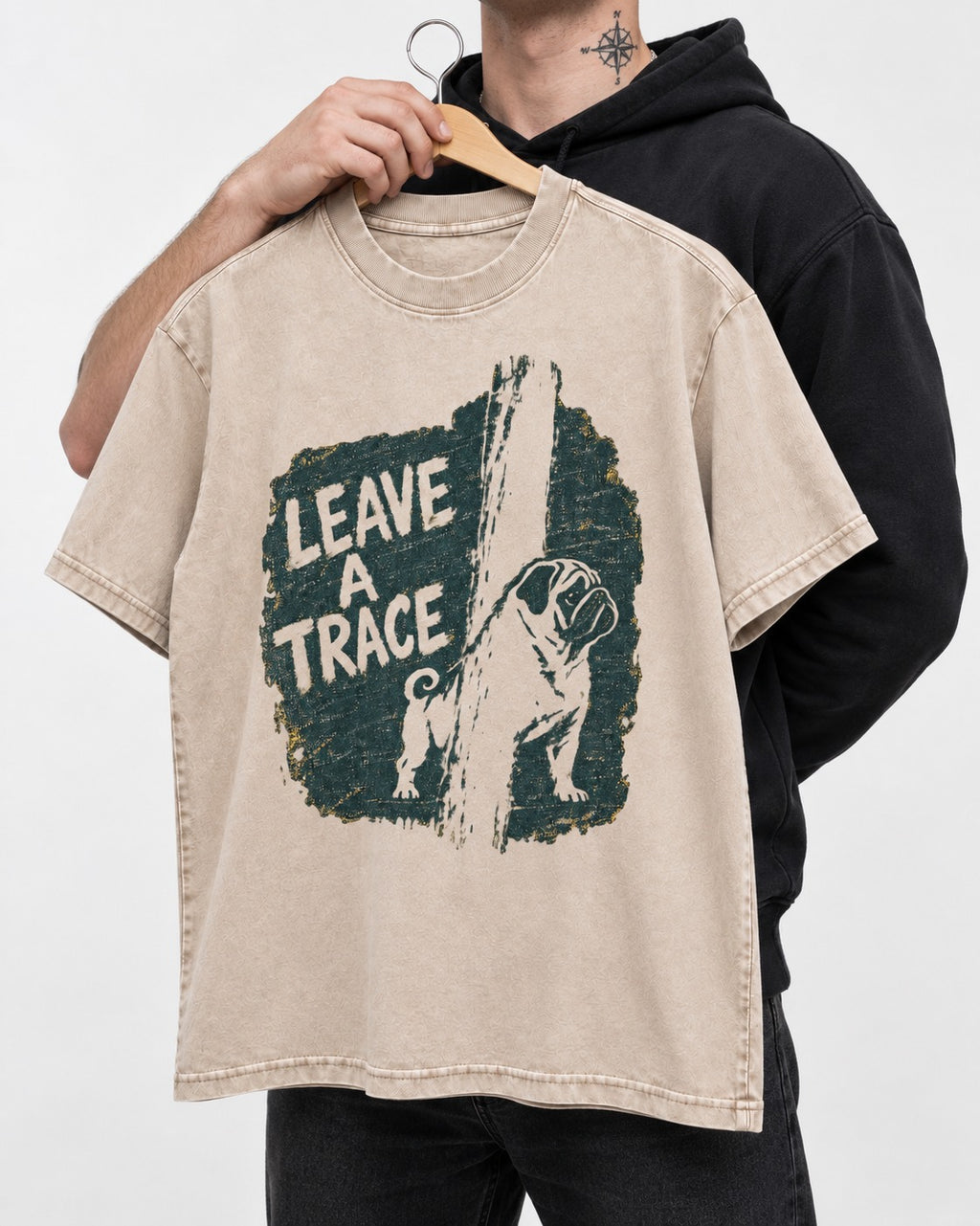 Pug Leaves a Trace Washed Tee in Apricot, held up on a hanger