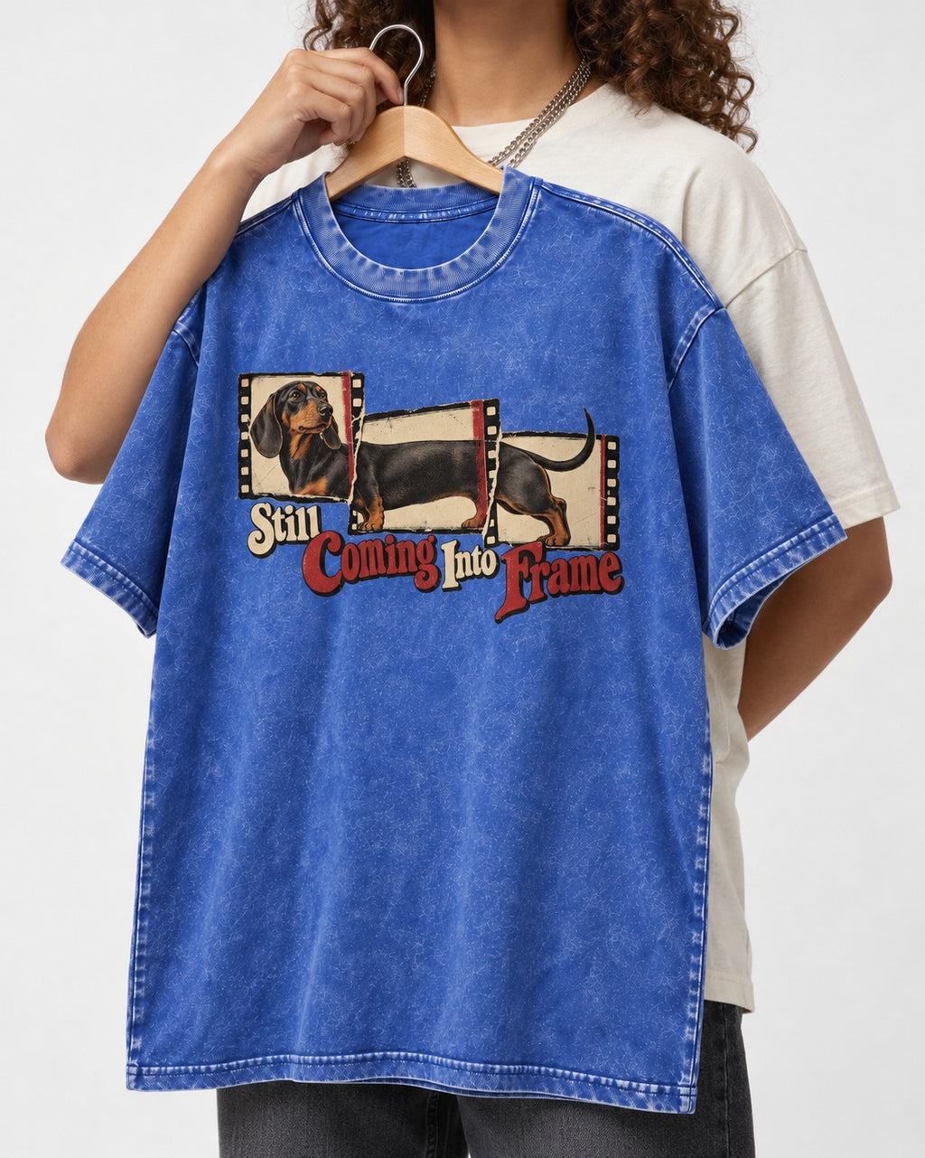 Dachshund Still Coming Into Frame Vintage Filmstrip Graphic Washed Tee in Royal Blue, held up on a hanger