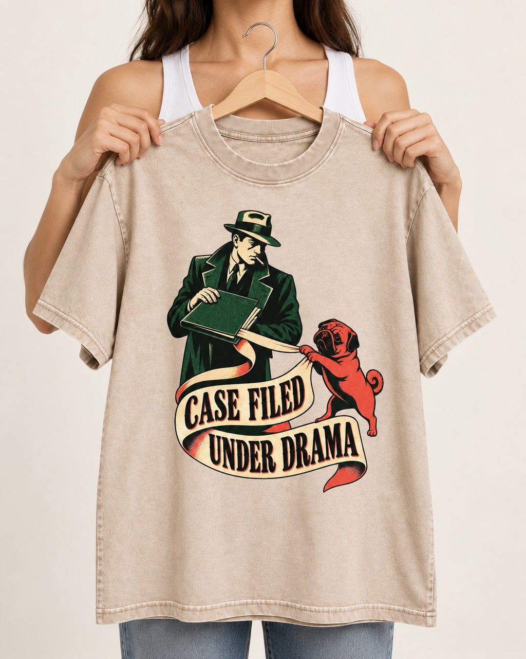 Pug Case Filed Under Drama Washed Tee in Apricot, held up on a hanger