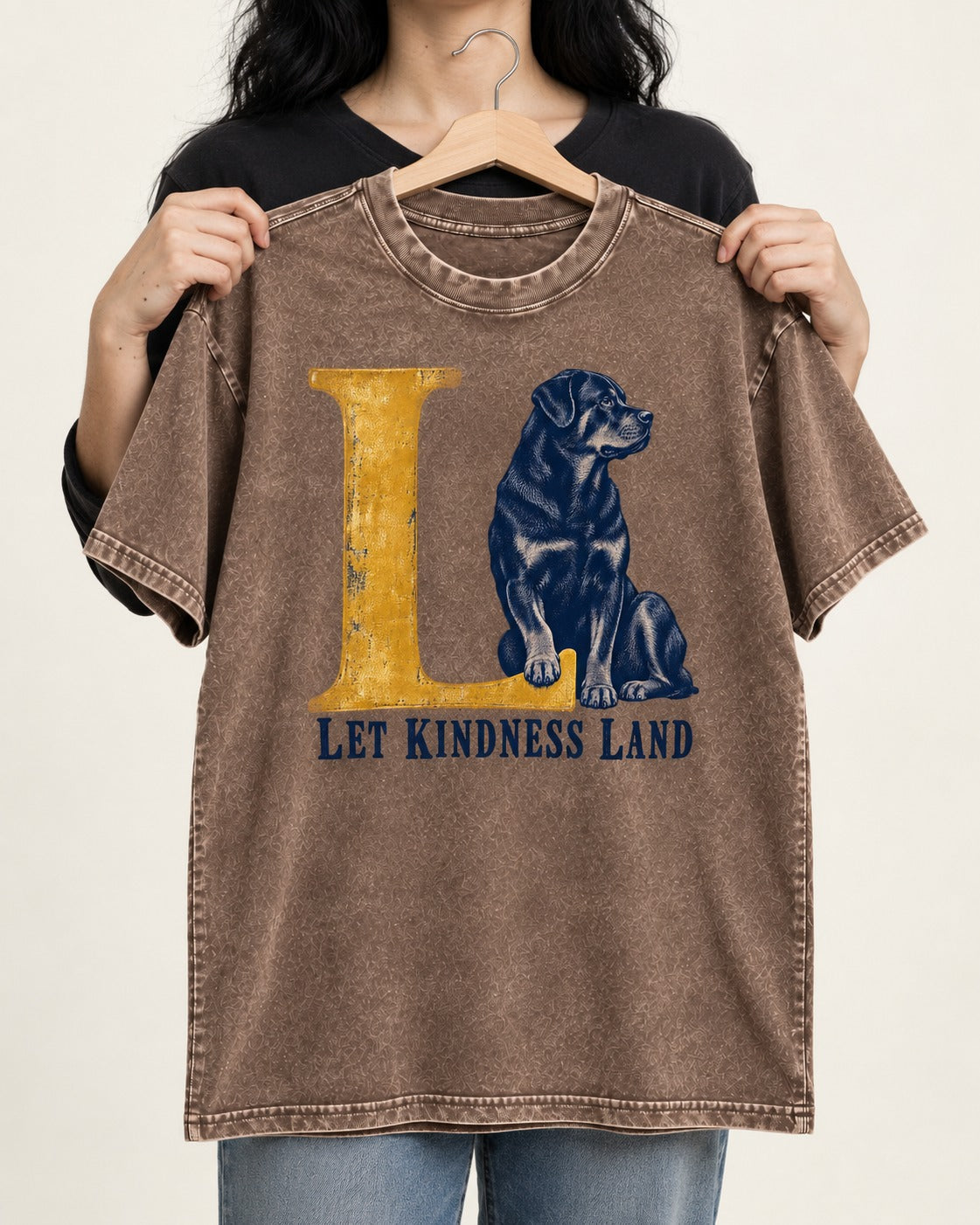 Let Kindness Lead Rottweiler Washed Tee in Coffee, held up on a hanger