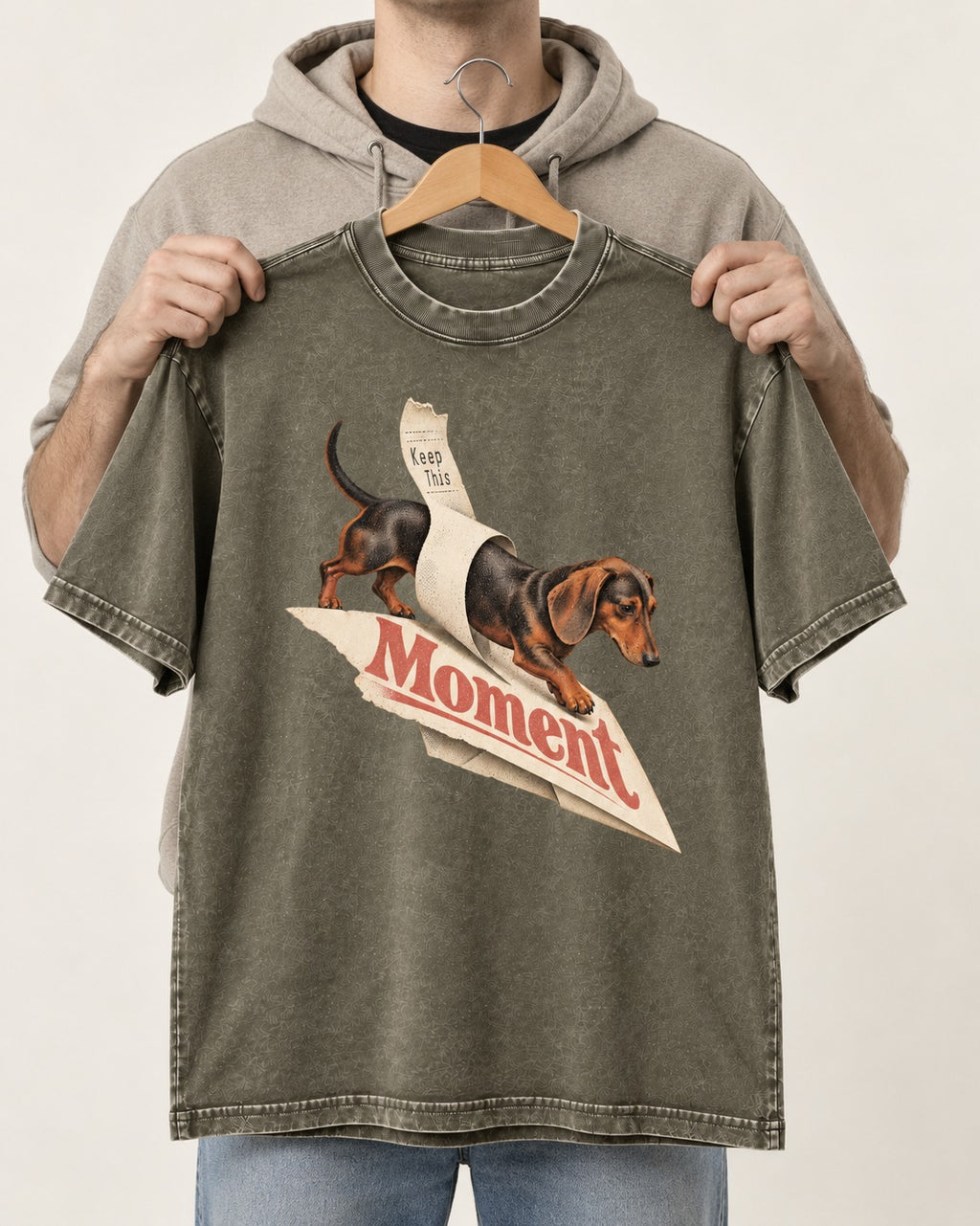 Dachshund Keep This Moment Receipt Graphic Washed Tee in Army Green, held up on a hanger