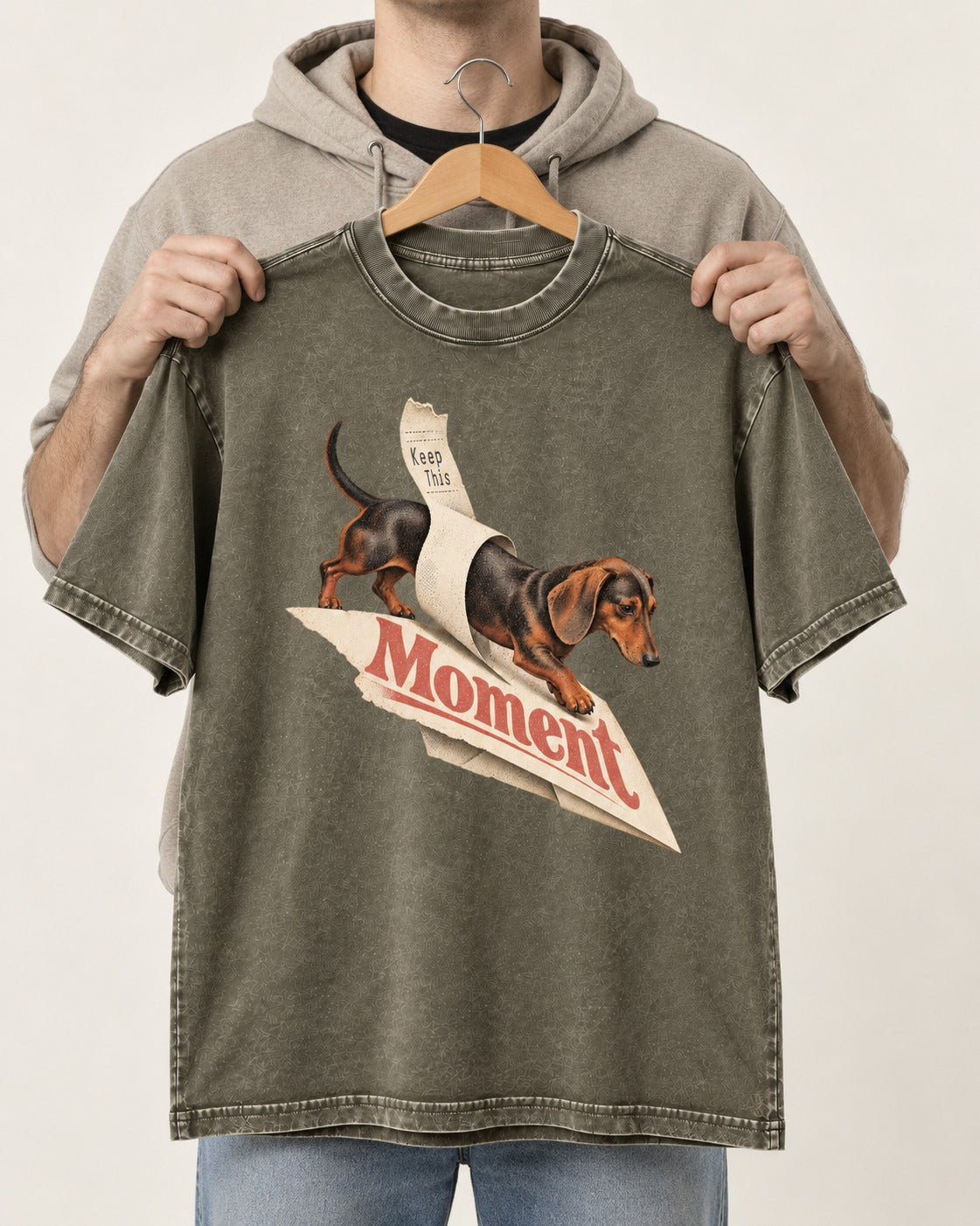 Dachshund Keep This Moment Receipt Graphic Washed Tee in Army Green, held up on a hanger