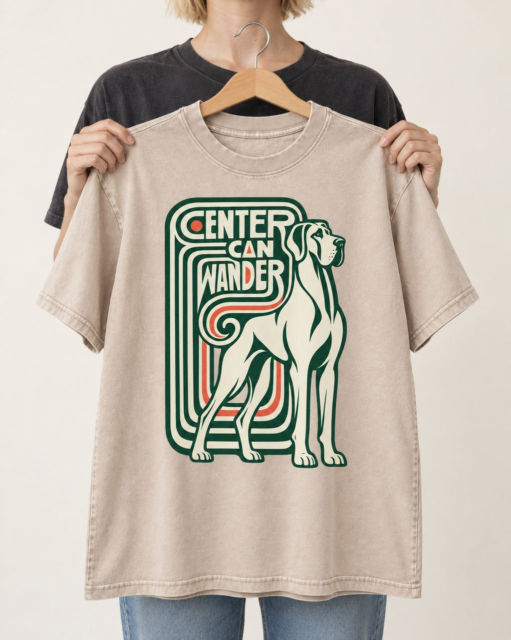 Great Dane Center Can Wander Washed Tee in Apricot, held up on a hanger