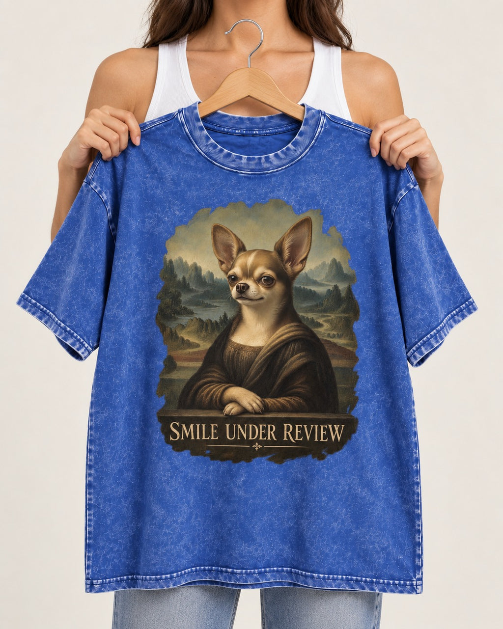 Chihuahua Smile Under Review Mona Lisa Portrait Washed Tee in Royal Blue, held up on a hanger