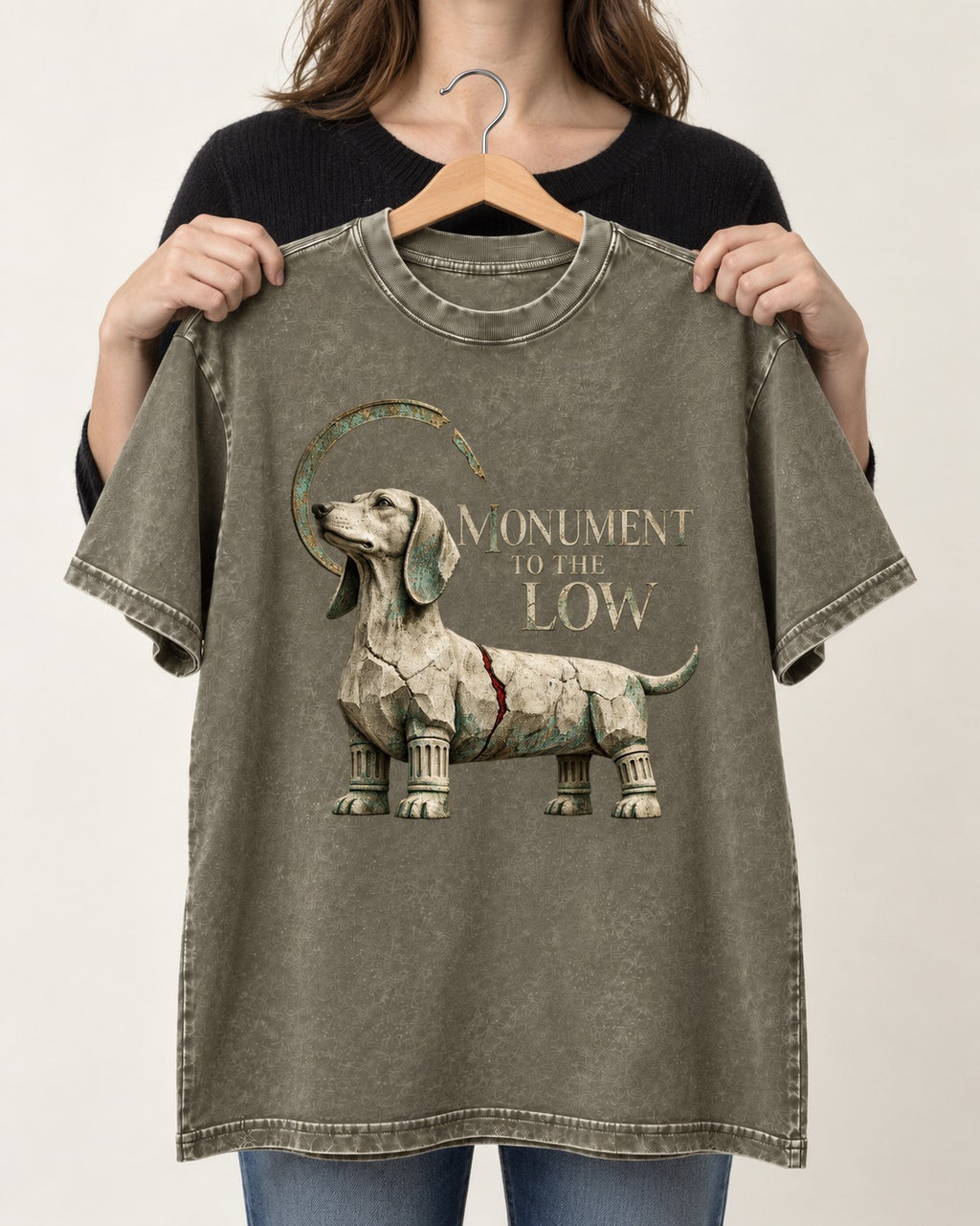 Dachshund Monument to the Low Stone Statue Graphic Washed Tee in Army Green, held up on a hanger