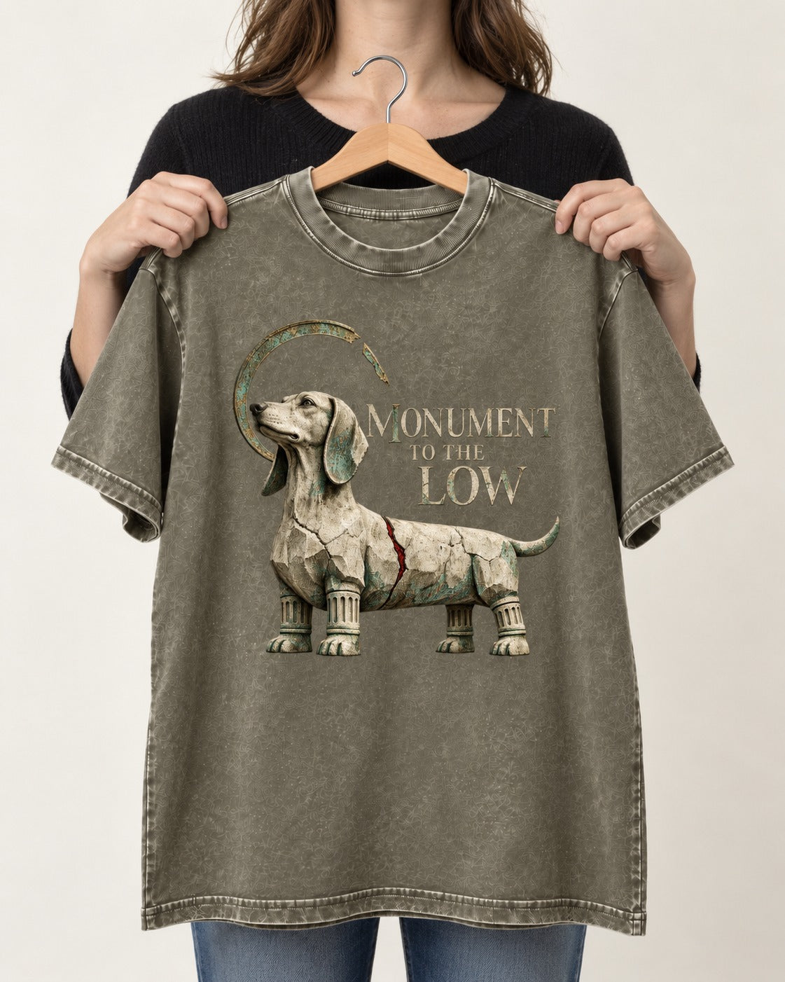 Dachshund Monument to the Low Stone Statue Graphic Washed Tee in Army Green, held up on a hanger