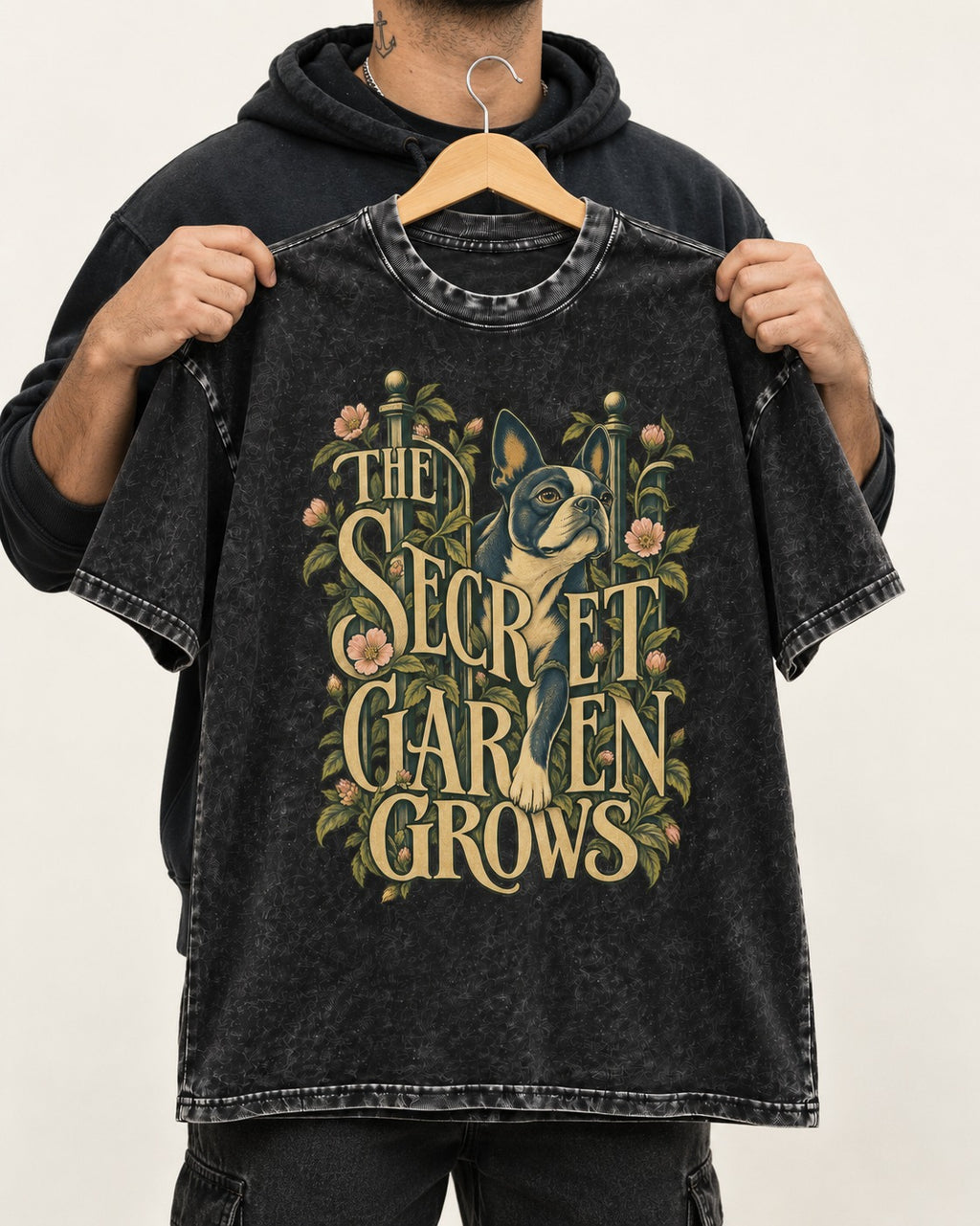 The Secret Garden Grows Boston Terrier Washed Tee in Black, held up on a hanger