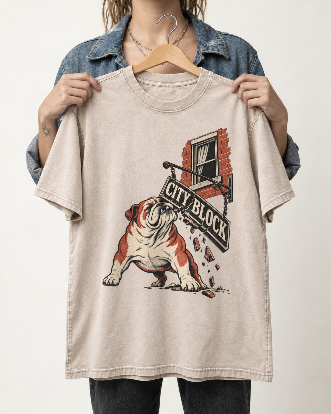 English Bulldog City Block Breaking Sign Graphic Washed Tee in Apricot, held up on a hanger