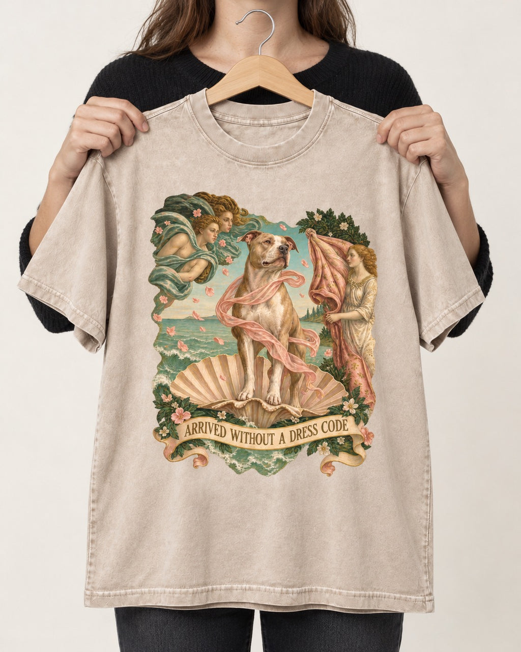 Pitbull Arrived Without a Dress Code Venus Parody Graphic Washed Tee in Apricot, held up on a hanger