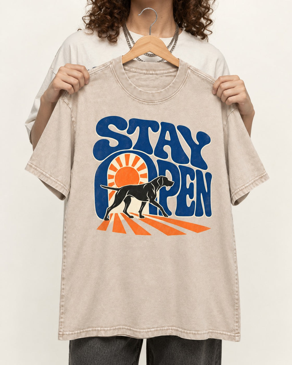 Stay Open German Shorthaired Pointer Washed Tee in Apricot, held up on a hanger