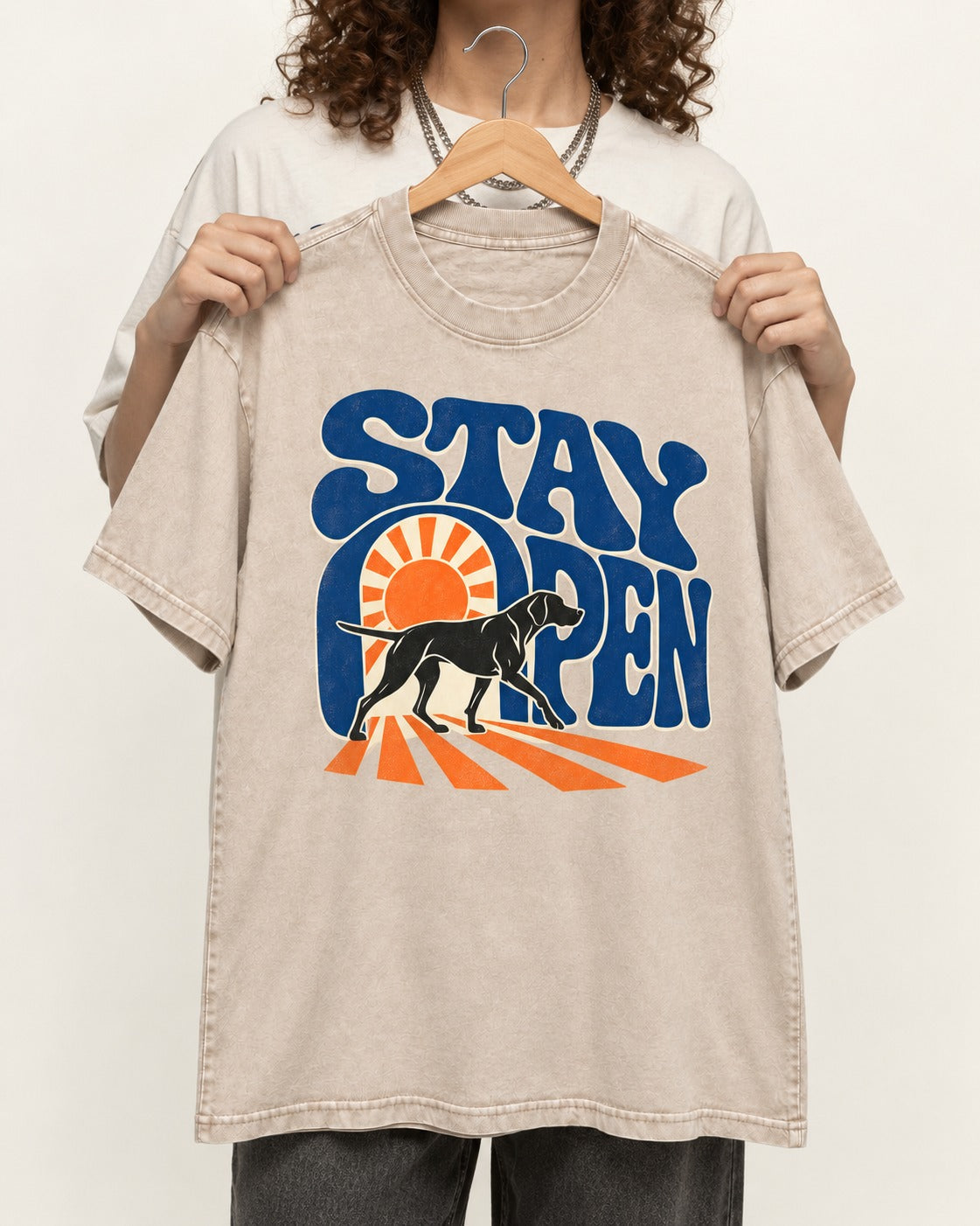 Stay Open German Shorthaired Pointer Washed Tee in Apricot, held up on a hanger