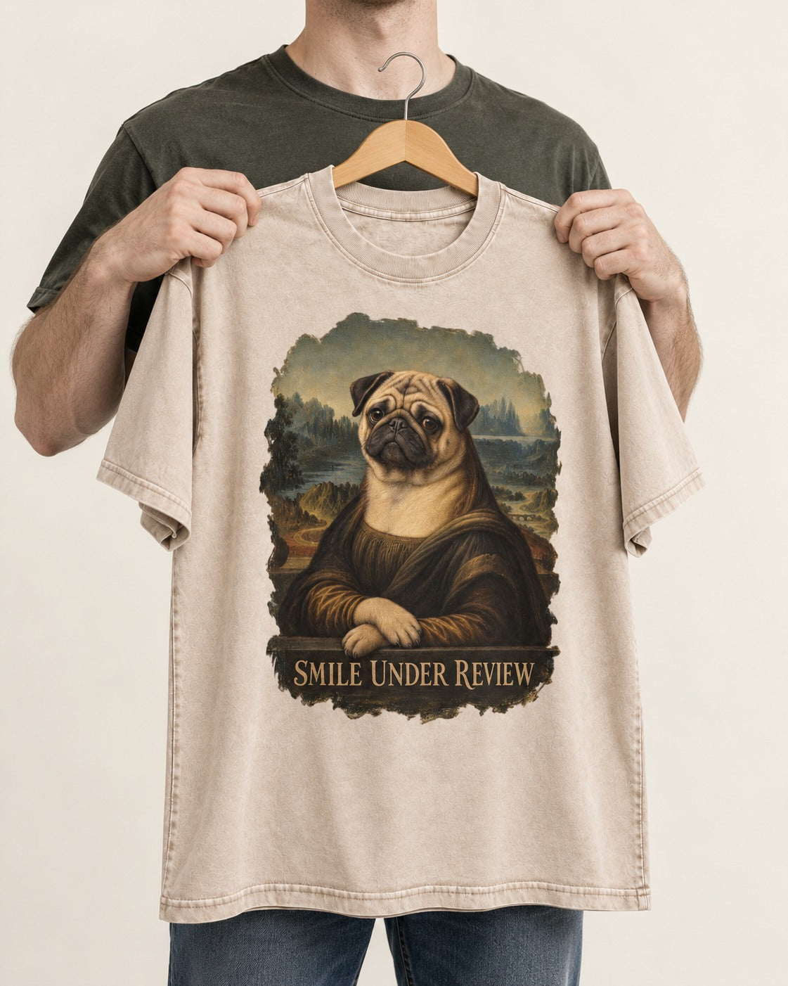 Pug Smile Under Review Mona Lisa Graphic Washed Tee in Apricot, held up on a hanger