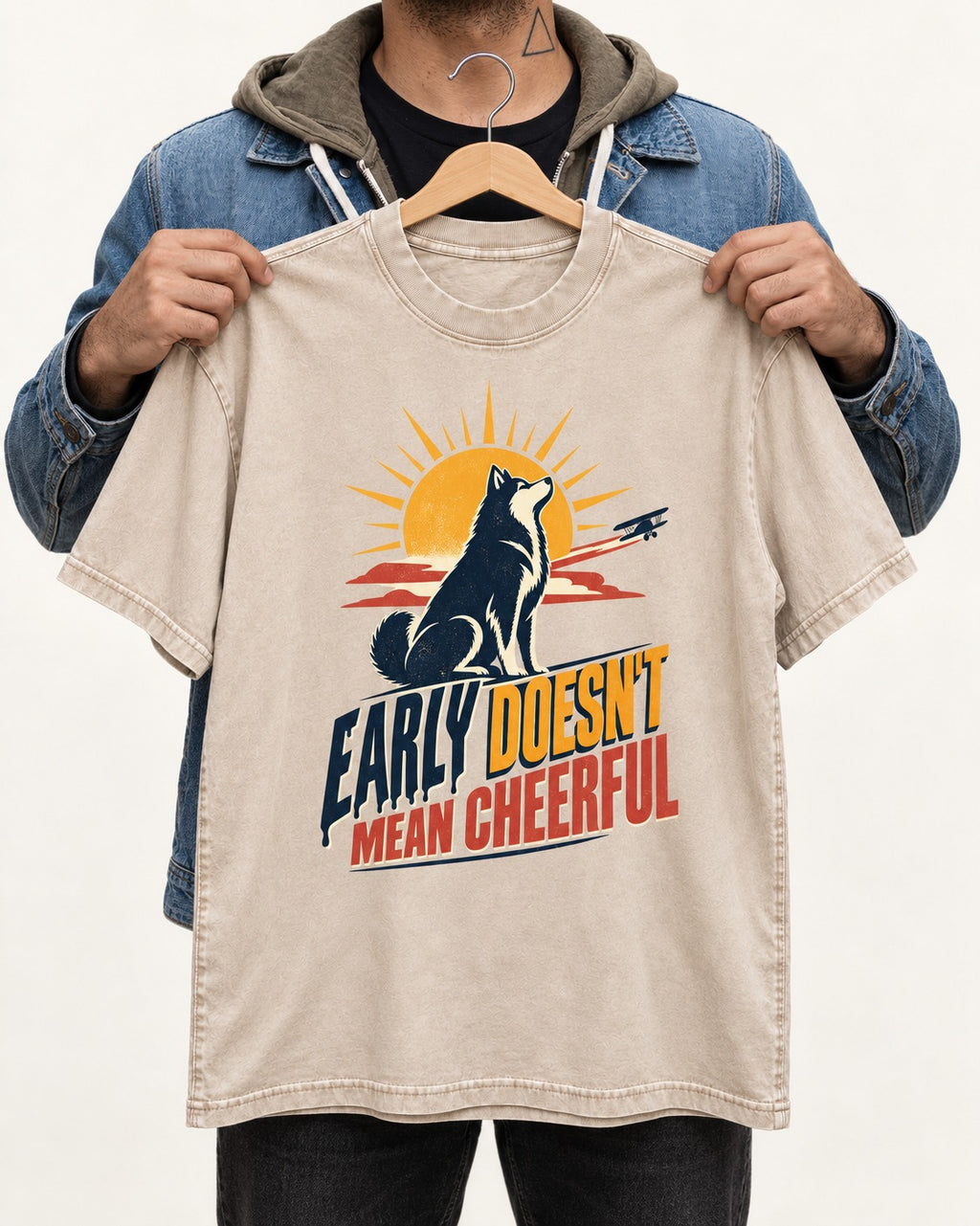 Husky Early Doesnt Mean Cheerful Sunrise Airplane Graphic Washed Tee in Apricot, held up on a hanger