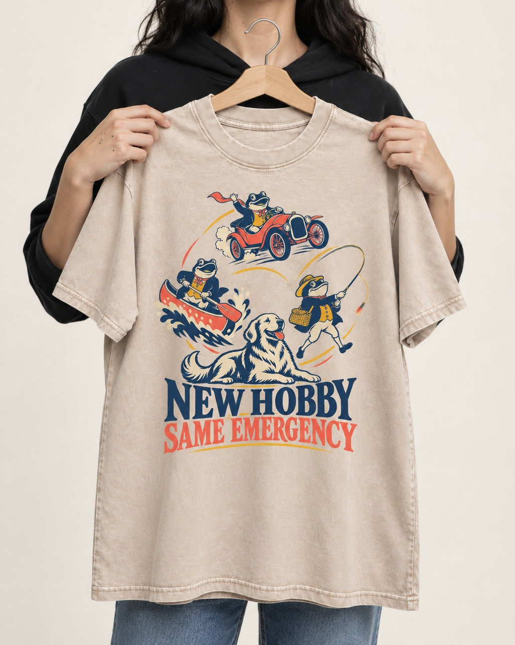 Golden Retriever New Hobby Same Emergency Washed Tee in Apricot, held up on a hanger