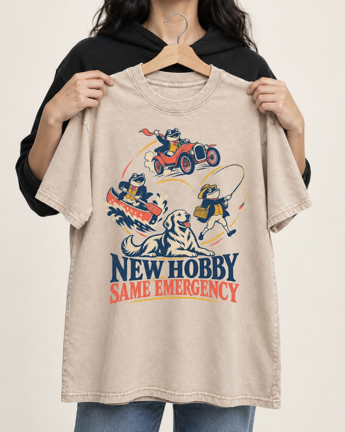 Golden Retriever New Hobby Same Emergency Washed Tee in Apricot, held up on a hanger
