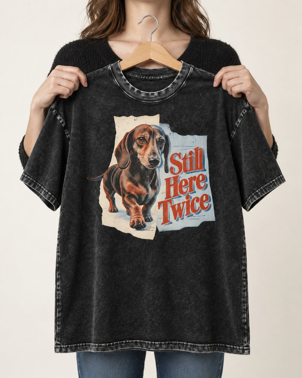 Dachshund Still Here Twice Torn Paper Graphic Washed Tee in Black, held up on a hanger