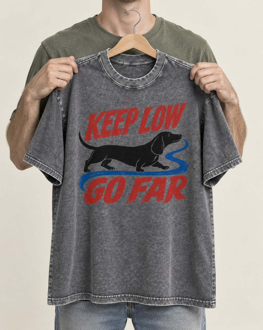 Keep Low Go Far Dachshund Washed Tee in Gray, held up on a hanger