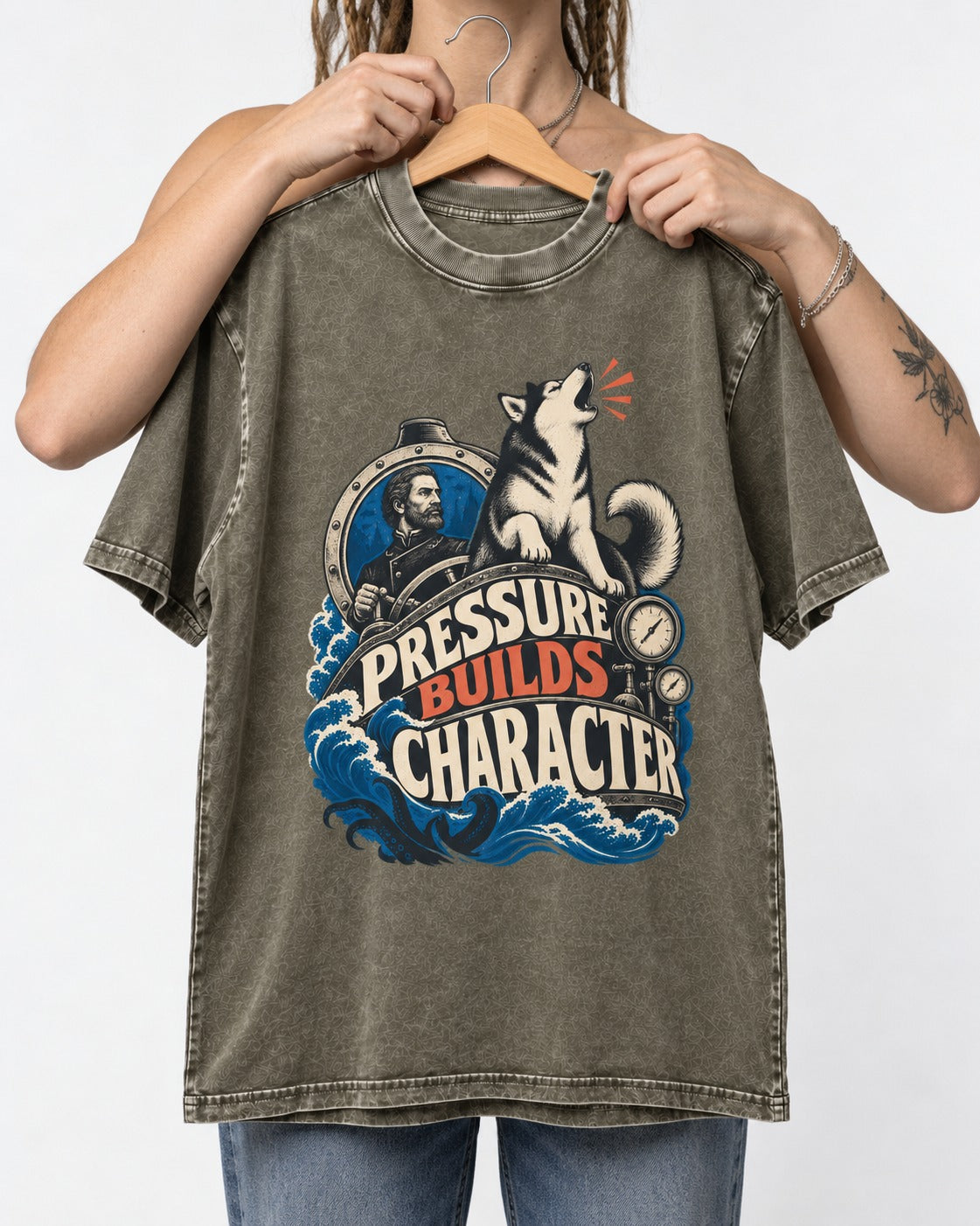 Husky Pressure Builds Character Deep Sea Graphic Washed Tee in Army Green, held up on a hanger