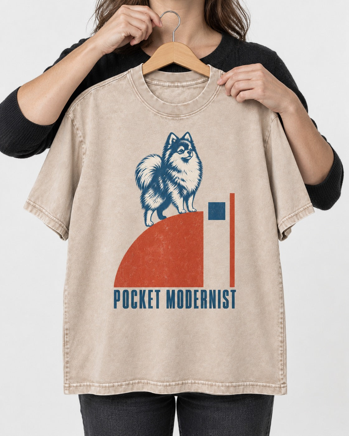 Pocket Modernist Pomeranian Washed Tee in Apricot, held up on a hanger