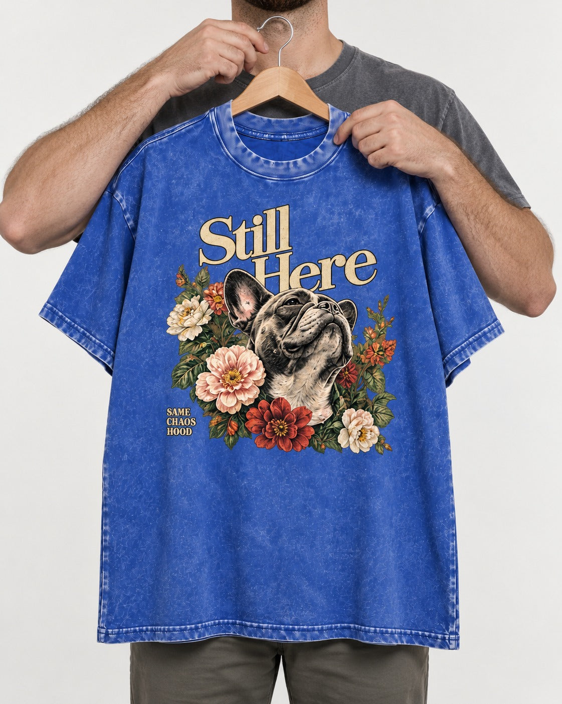 Frenchie Still Here Floral Portrait Graphic Washed Tee in Royal Blue, held up on a hanger