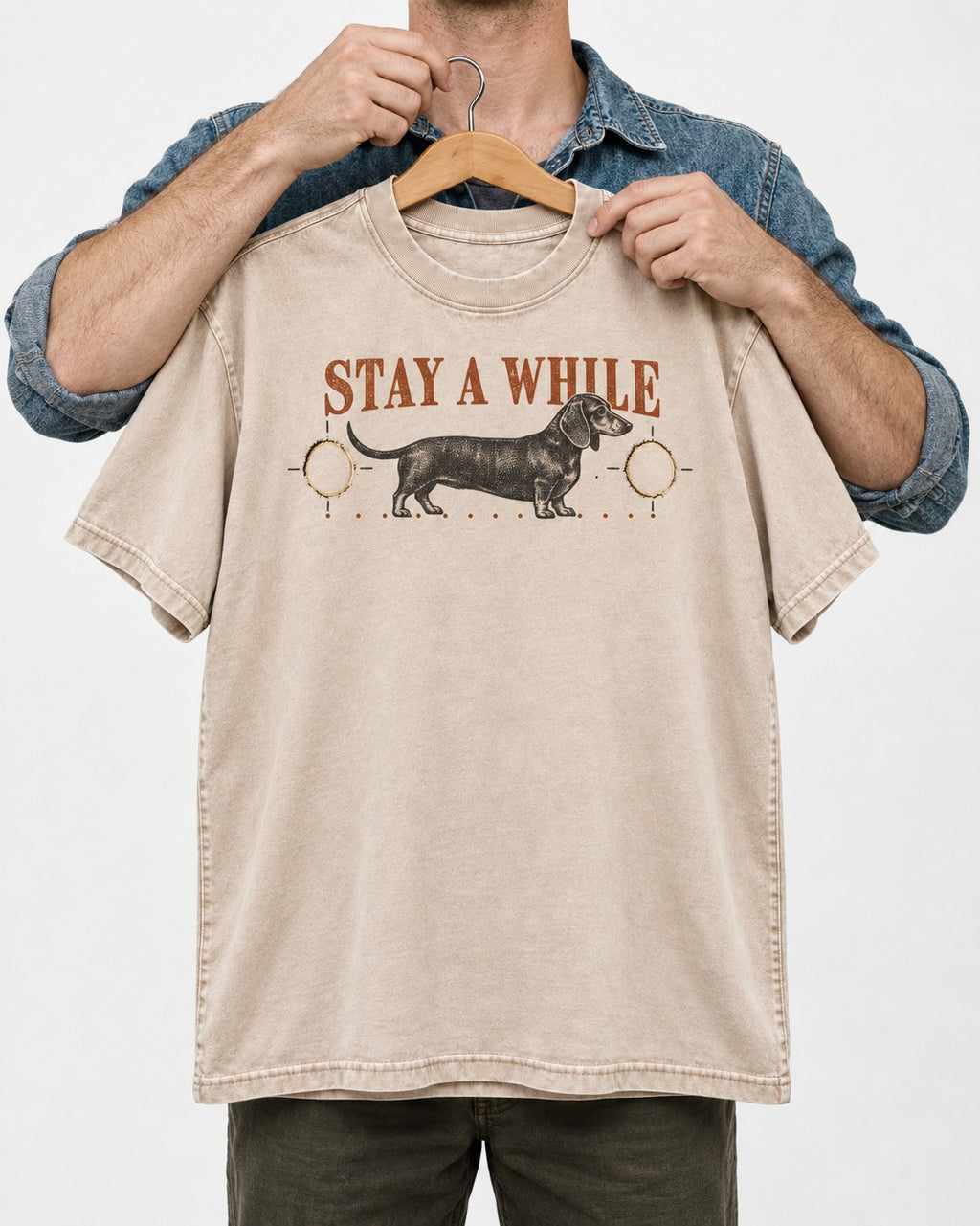 Dachshund Stay A While Ornamental Portrait Graphic Washed Tee in Apricot, held up on a hanger