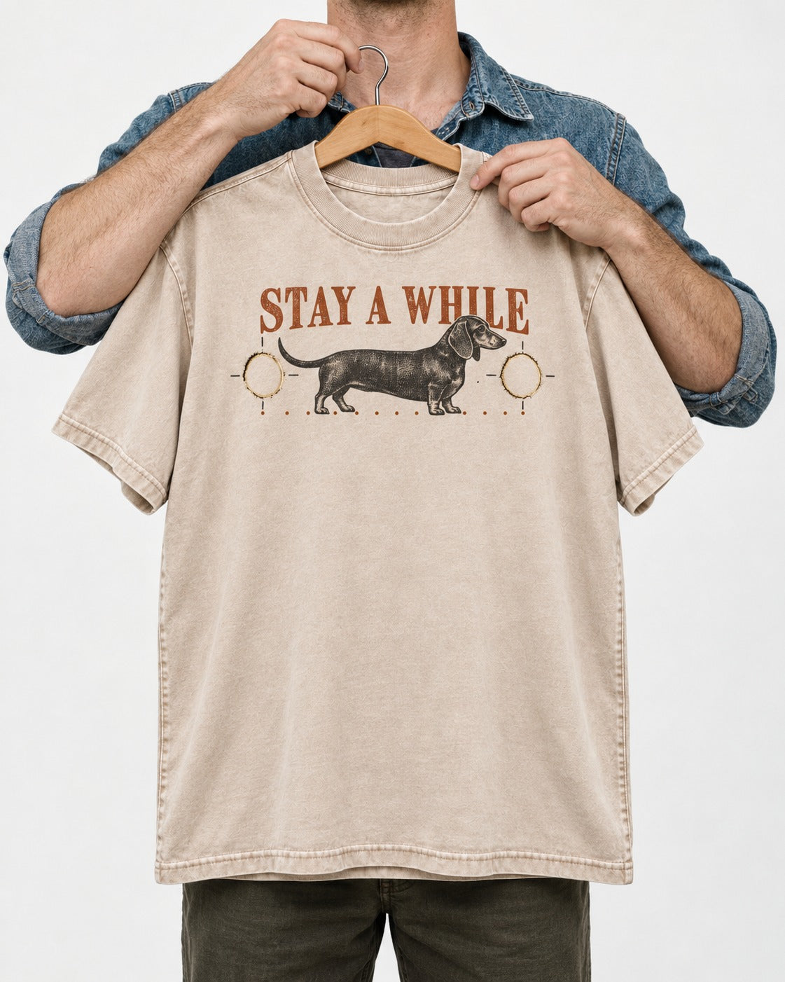 Dachshund Stay A While Ornamental Portrait Graphic Washed Tee in Apricot, held up on a hanger