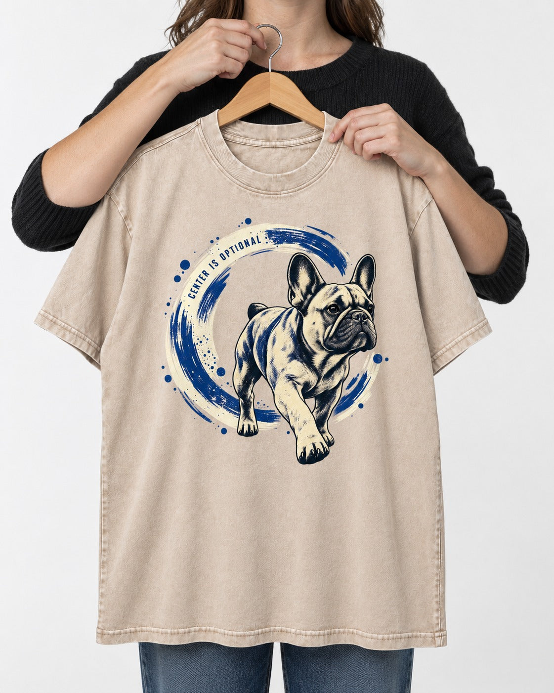 Frenchie Center Is Optional Brush Circle Graphic Washed Tee in Apricot, held up on a hanger