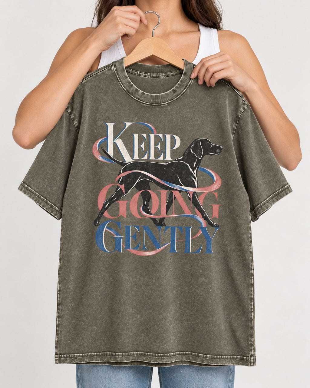 German Shorthaired Pointer Keep Going Gently Walking Graphic Washed Tee in Army Green, held up on a hanger
