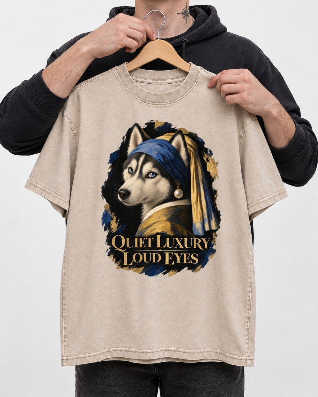 Husky Quiet Luxury Loud Eyes Pearl Portrait Graphic Washed Tee in Apricot, held up on a hanger