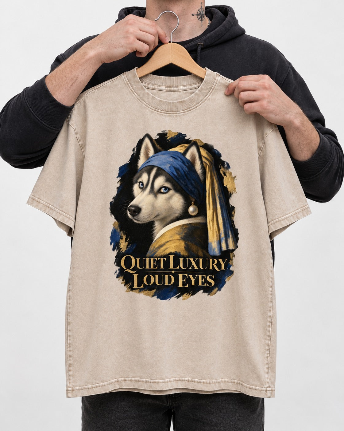 Husky Quiet Luxury Loud Eyes Pearl Portrait Graphic Washed Tee in Apricot, held up on a hanger