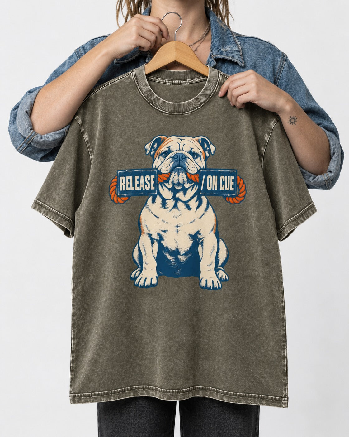 English Bulldog Release on Cue Rope Sign Graphic Washed Tee in Army Green, held up on a hanger