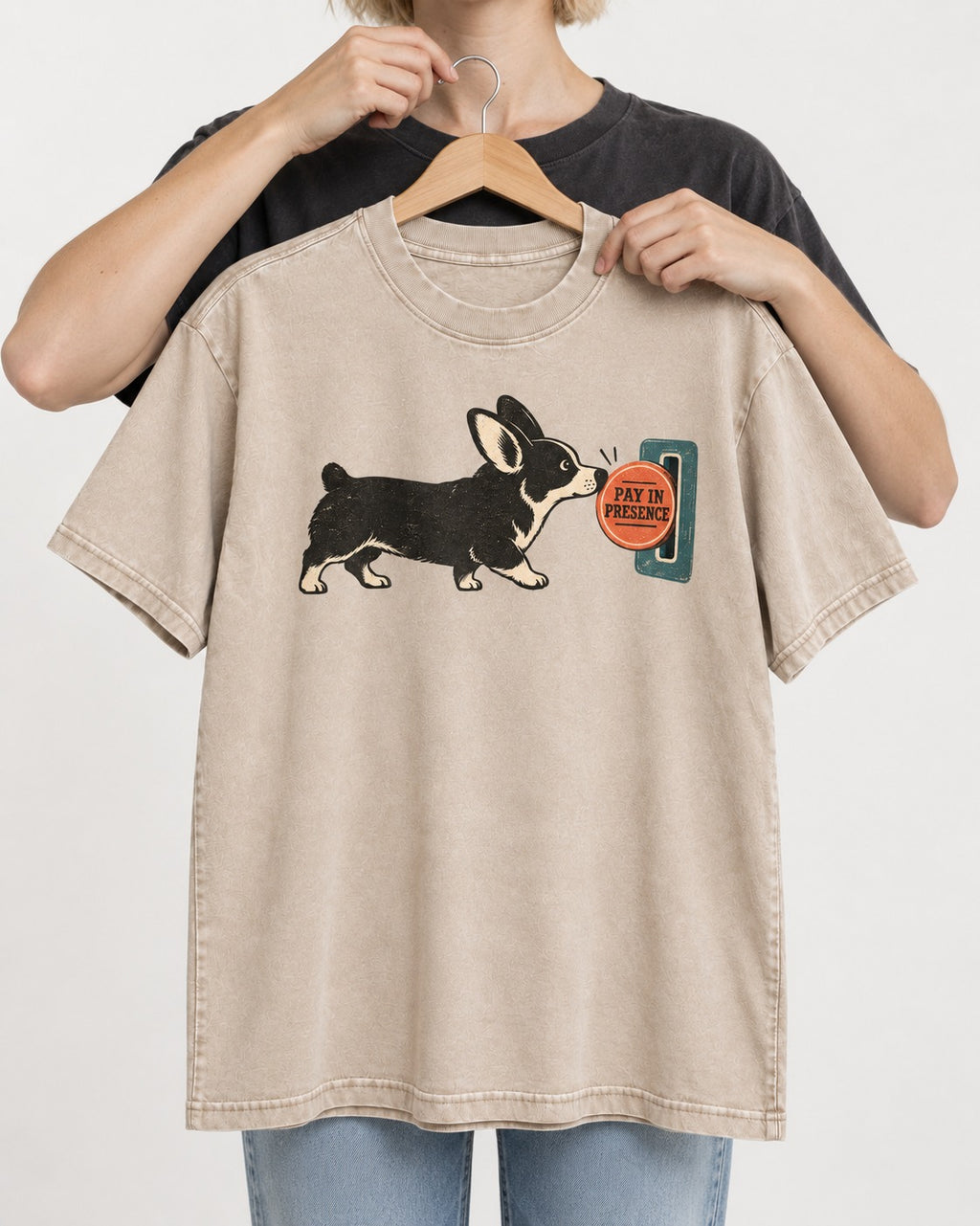 Corgi Pay in Presence Washed Tee in Apricot, held up on a hanger