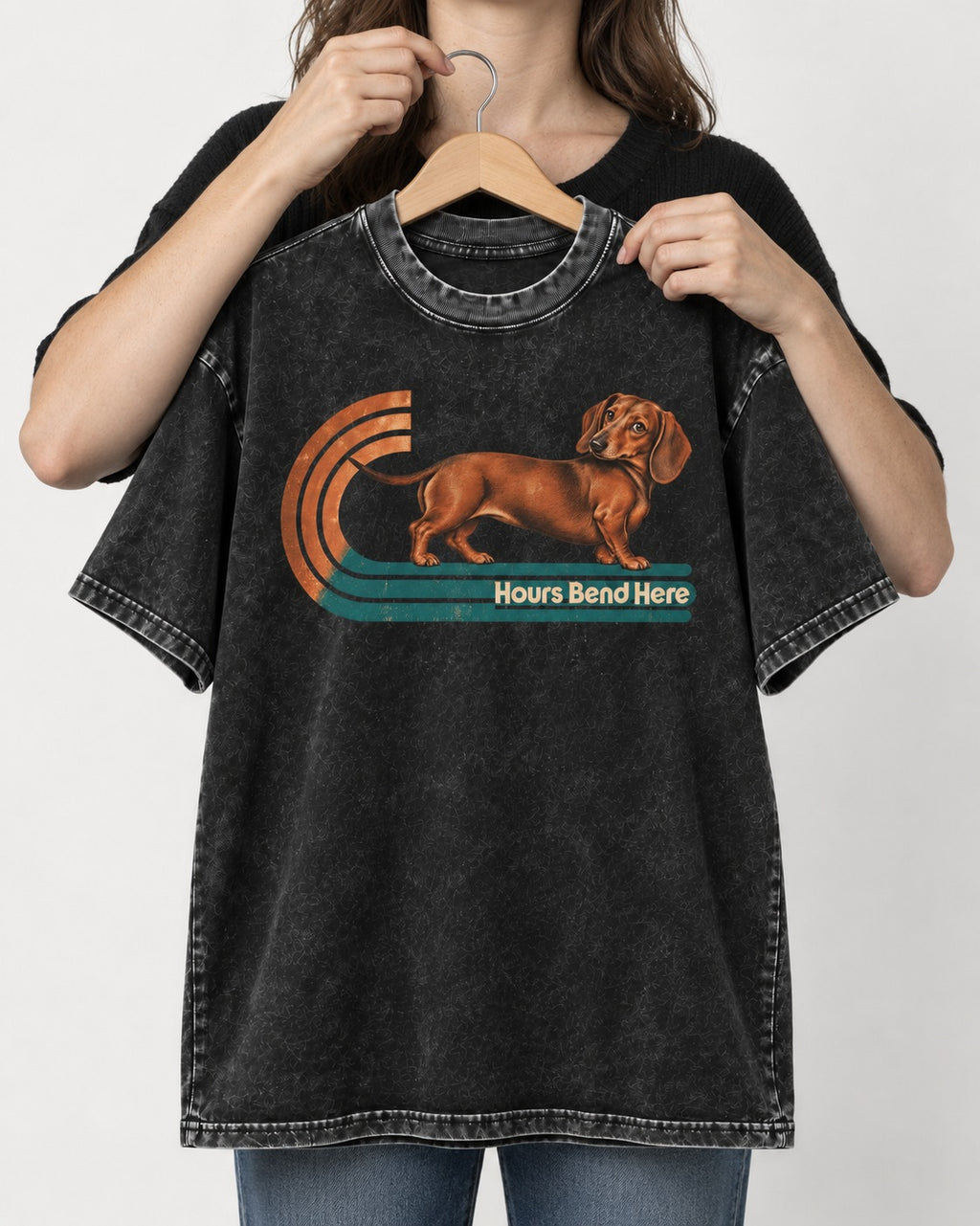 Dachshund Hours Bend Here Retro Track Graphic Washed Tee in Black, held up on a hanger