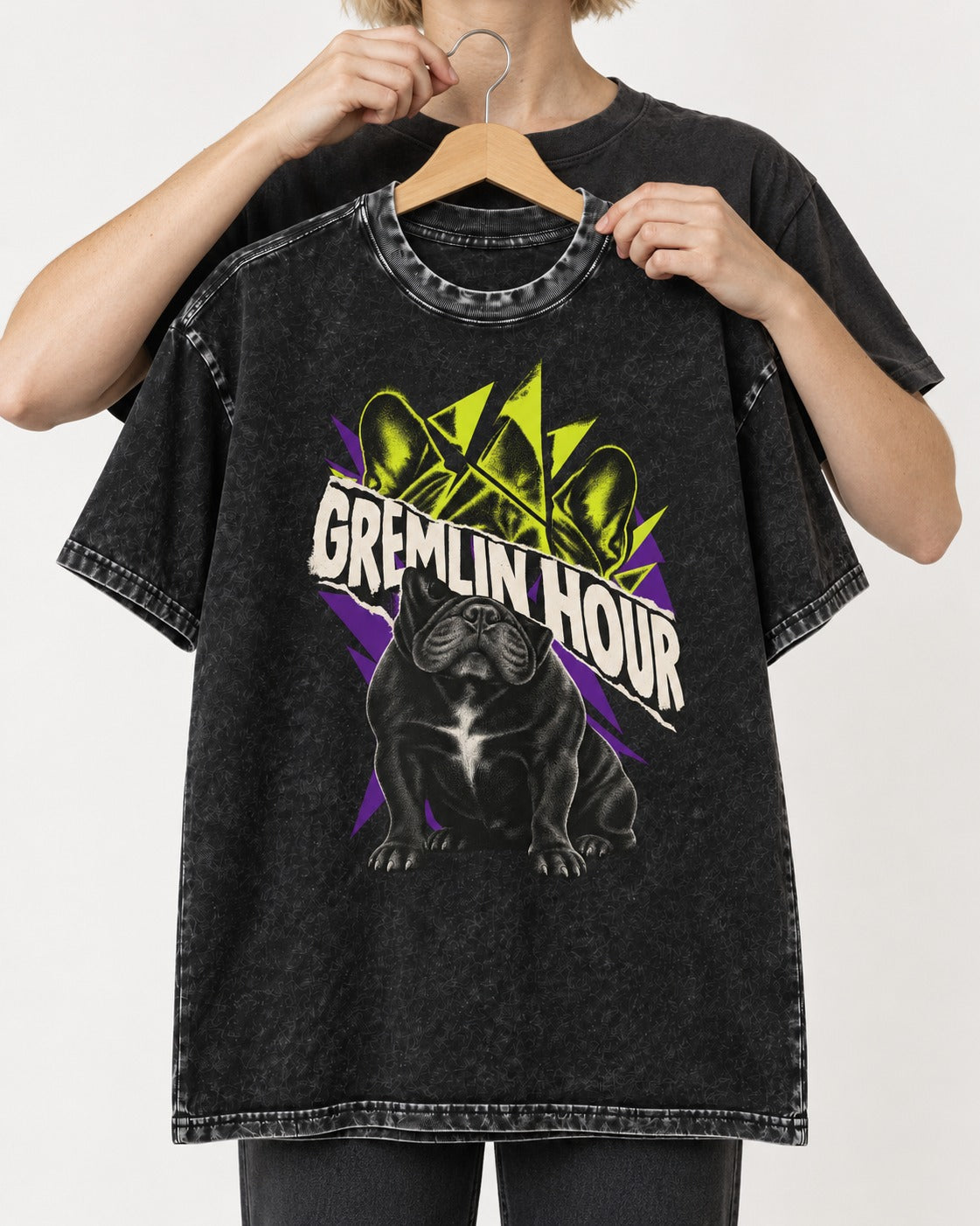 Frenchie Gremlin Hour Fracture Portrait Graphic Washed Tee in Black, held up on a hanger