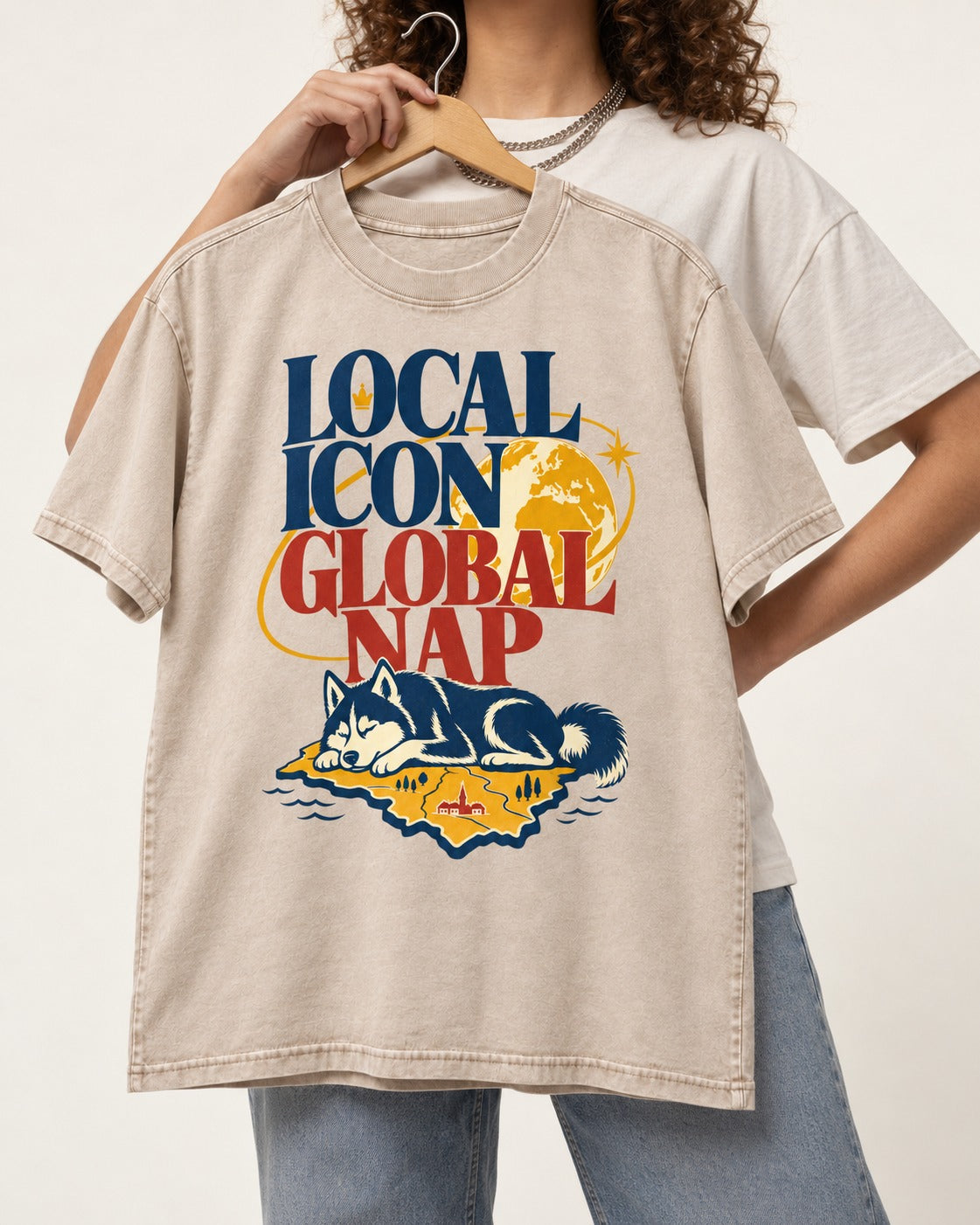 Husky Local Icon Global Nap Washed Tee in Apricot, held up on a hanger